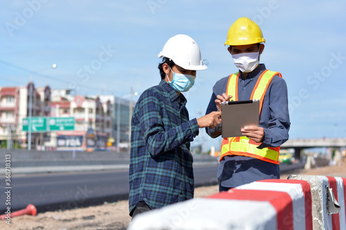 Asian Engineer Construction are Worker employee Worker By safety control helmet on site building