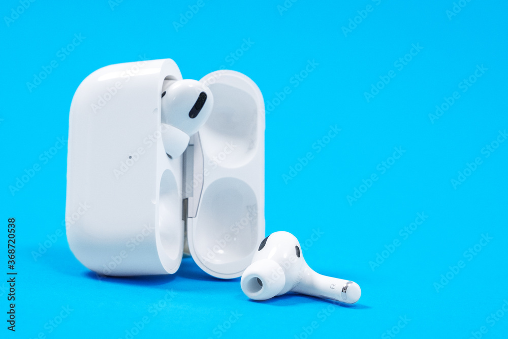 Rostov, Russia - July 06, 2020: Wireless headphones Apple AirPods Pro in  opened charging case with active noise cancellation immersive sound, on  blue background, copy space Stock 写真 | Adobe Stock