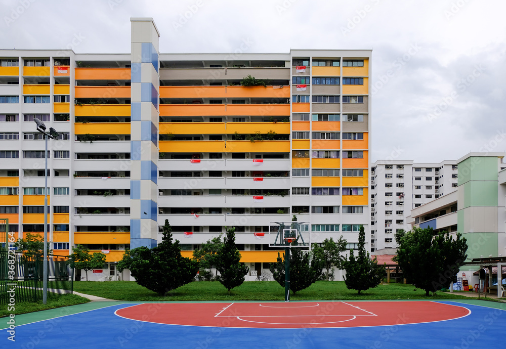 Colourful block of common HDB flats (painted in white yellow orange