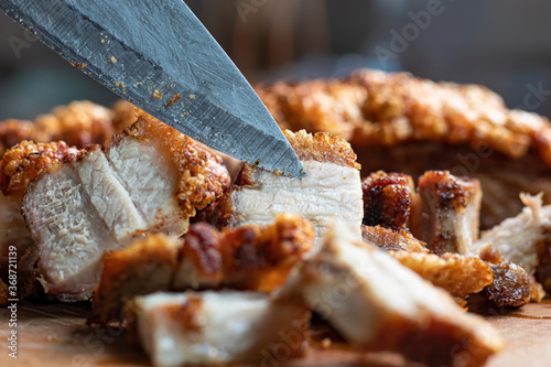 Close up Oriental Roast Crispy pork belly on wooden chopping board