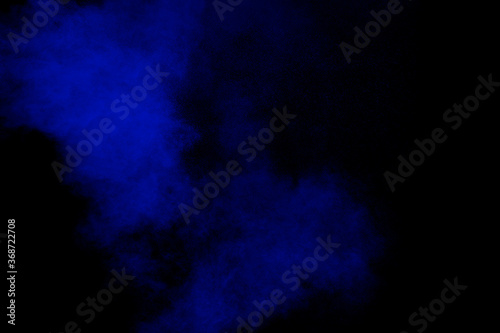 Blue color dust particles explosion cloud on black background.Color powder splash.