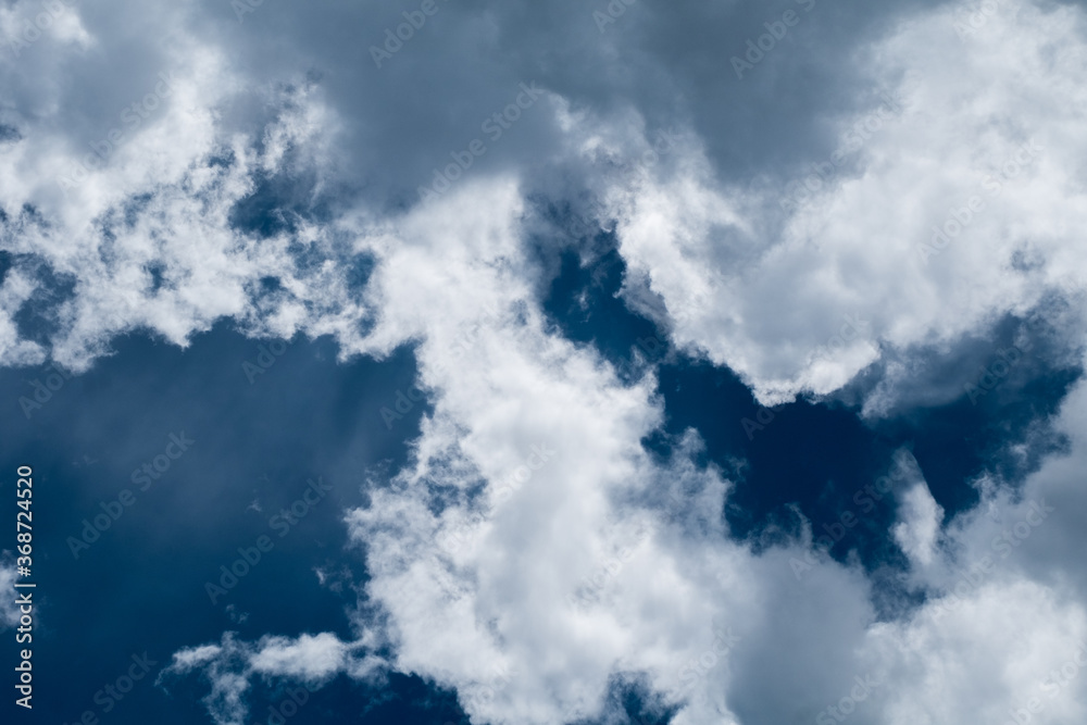 Obraz premium floating white cloud in bright blue sky in sunny day 