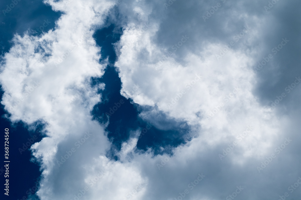 Obraz premium floating white cloud in bright blue sky in sunny day 