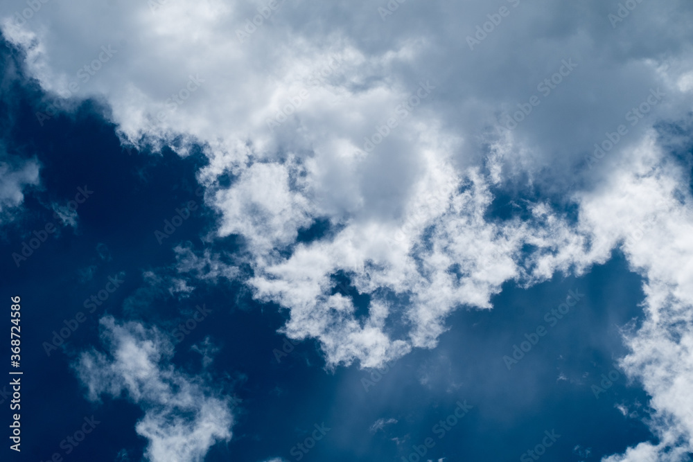 Obraz premium floating white cloud in bright blue sky in sunny day 