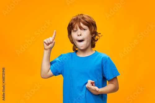 red-haired boy shows thumb up and free space