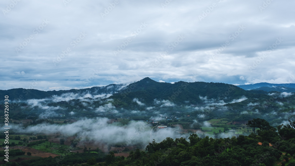 Landscape image of foggy greenery rainforest mountains and hills