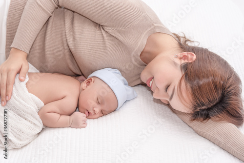 Close up beautiful young asian mother laying down smiling with son. Healthcare and medical.  lovely asian woman lifestyle mother's day concept.