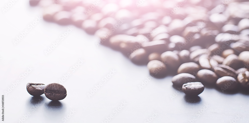Coffee beans with green leaves for cooking. Bag of coffee. Coffee beans roasted on the table. Coffee beans with green leaves for cooking. Bag of coffee. Coffee beans roasted on the table.