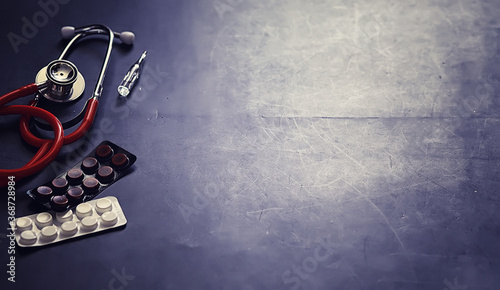 Background medical concept. Cardiologist's table. A stethoscope and medicine are prescribed by a doctor.