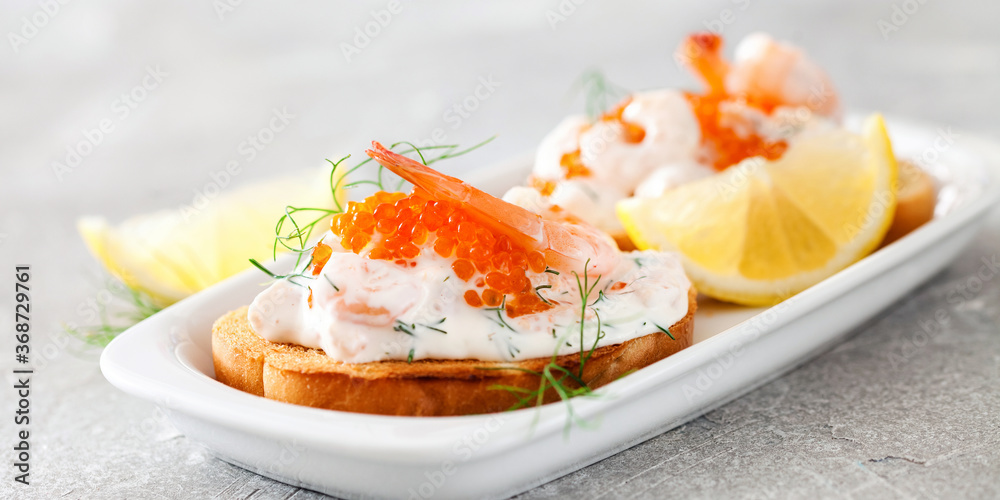 Toast skagen - shrimp and caviar on toast. Classic swedish appetizer. Selective focus. Copy space Toast skagen - shrimp and caviar on toast. Classic swedish appetizer. Selective focus. Copy space