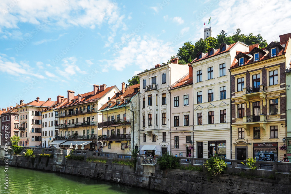 View on oldtown buildings, castle and Ljubljanica river in Ljubljana, Slovenia. Defocused
