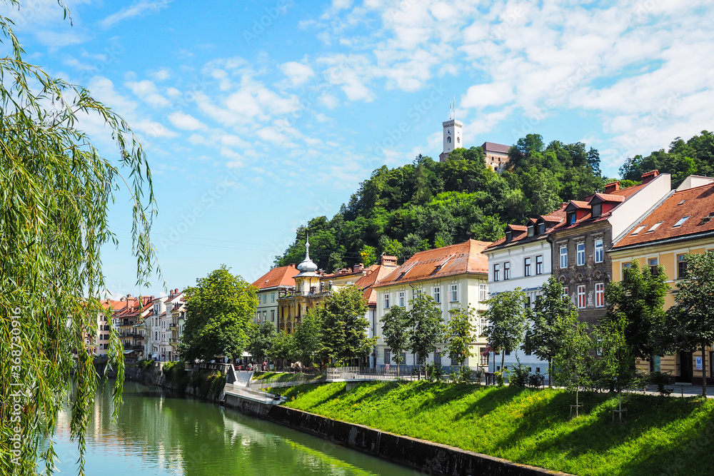 View on oldtown buildings, castle and Ljubljanica river in Ljubljana, Slovenia. Defocused