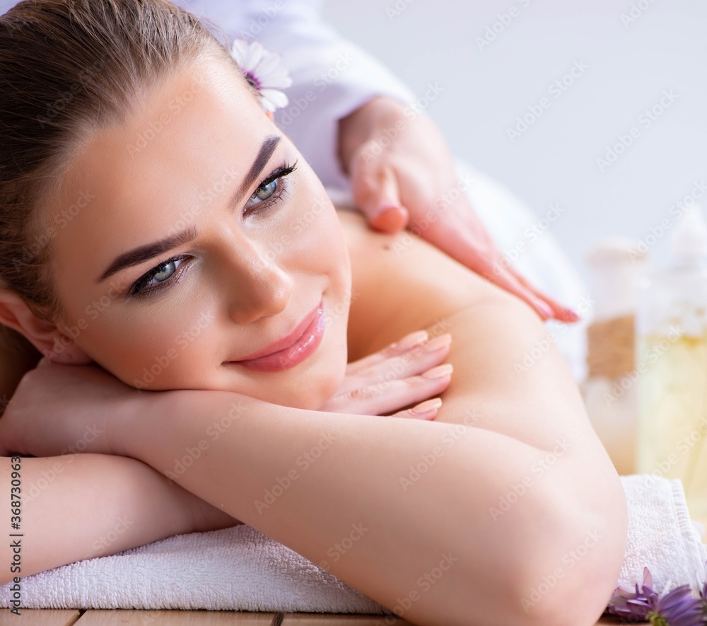 Woman during massage session in spa Woman during massage session in spa