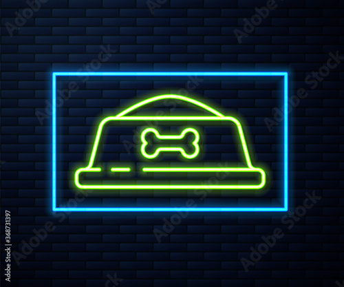 Glowing neon line Pet food bowl for cat or dog icon isolated on brick wall background. Dog bone sign. Vector.