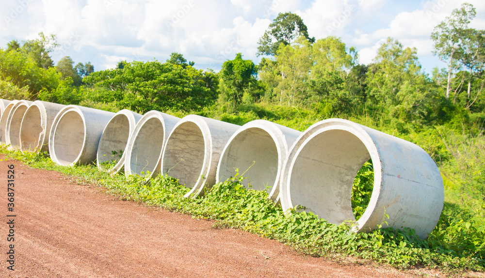 Cement pipes beside the countryside road. Cement pipes beside the countryside road.