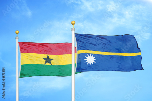 Ghana and Nauru two flags on flagpoles and blue sky