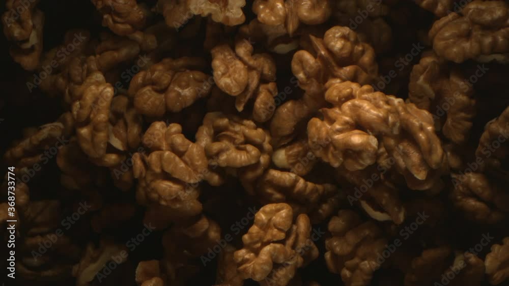 Walnut Nuts Thrown in the Air in High Speed Flying on Black Background 4k Walnut Nuts Thrown in the Air in High Speed Flying on Black Background 4k