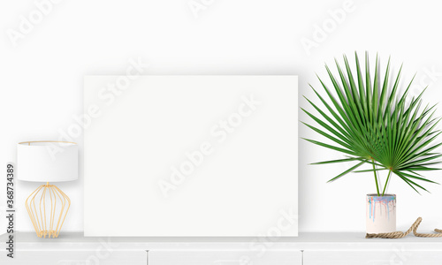 Interior horizontal rectangular poster mockup standing on the table with plant and decorations on empty white wall background. Rendering illustration.