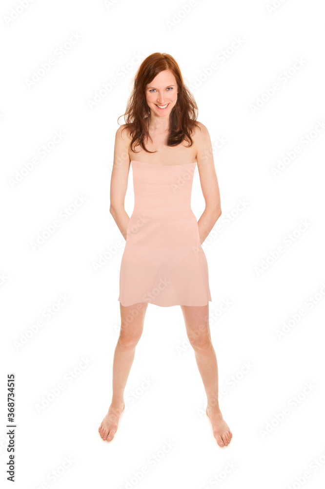 Highly attractive young woman wearing a short beige summer dress, full length portrait isolated in front of white studio background Highly attractive young woman wearing a short beige summer dress, full length portrait isolated in front of white studio background