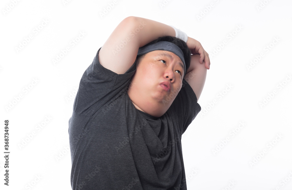 Young Asian funny fat sport man stretching before exercise isolated on white background. Young Asian funny fat sport man stretching before exercise isolated on white background.