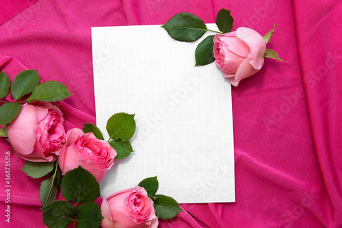 Romantic greeting card with space for text. Pink roses on fabric with paper. Frame for inscription. Congratulations on 8 march, valentains day, mothers day, birthday. Surprise to girl, girlfriend, mom photo