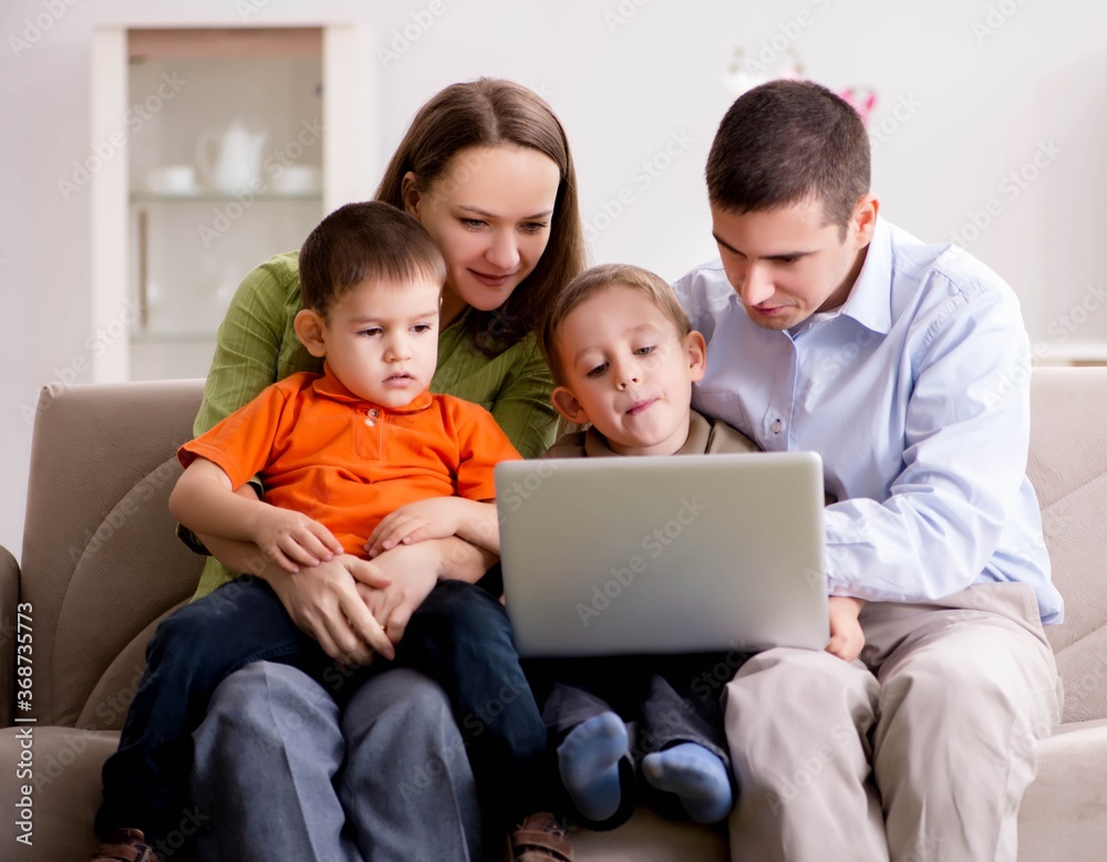 Young family surfing internet and looking at photos