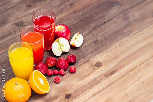 Citrus fruit and juice on table. multifruit juice. fresh vitamins, homemade refreshing fruit beverage. Orange, Strawberry, Apple.