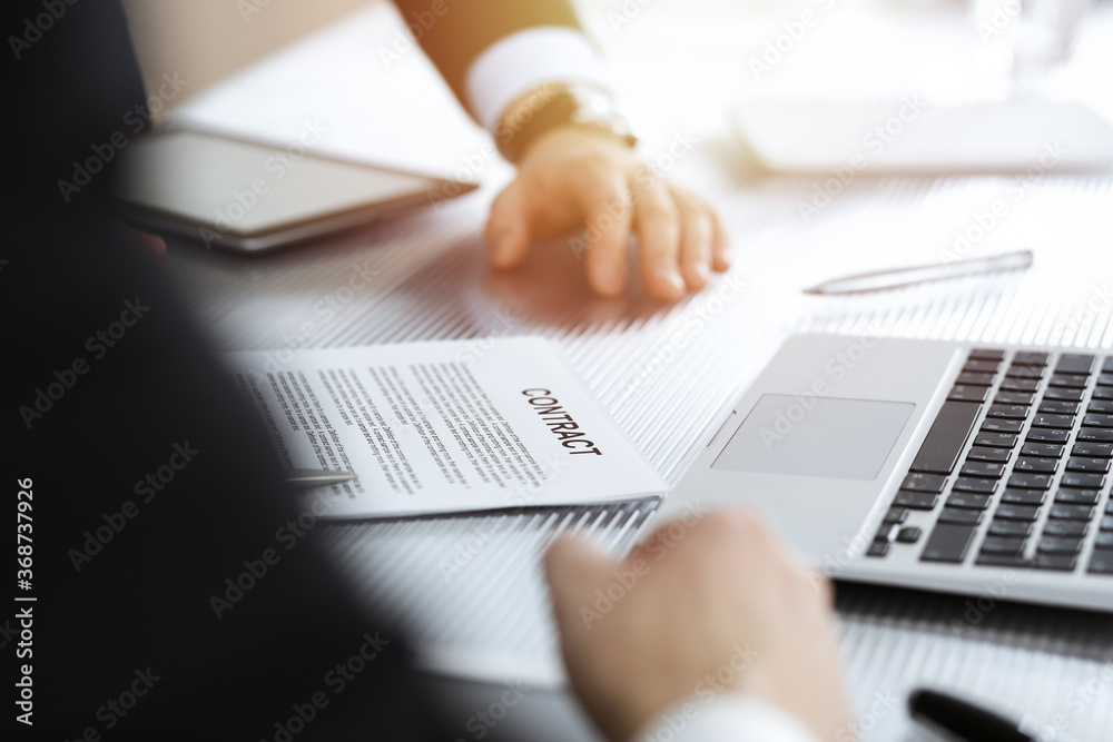 Business people shaking hands after contract signing in sunny modern office. Teamwork and handshake concept Business people shaking hands after contract signing in sunny modern office. Teamwork and handshake concept