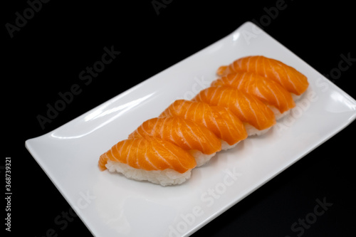 Salmon sushi nigiri isolated on black background
