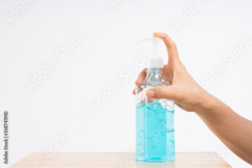 Hand pressing sanitizer alcohol gel bottl photo