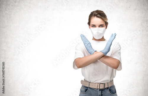 Woman in mask stops coronavirus, concrete