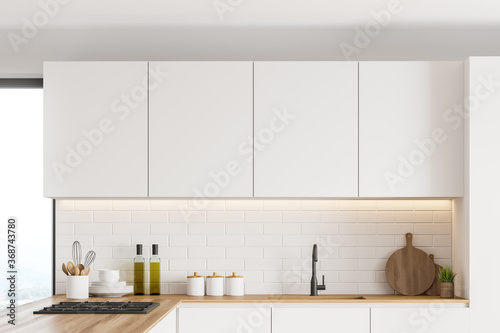 Cabinets in white kitchen interior