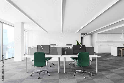 White open space office corner with green chairs