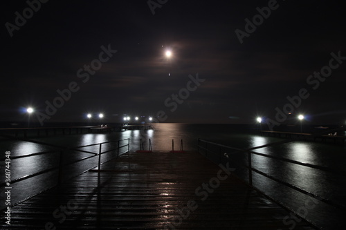 pier in the moonlight at night