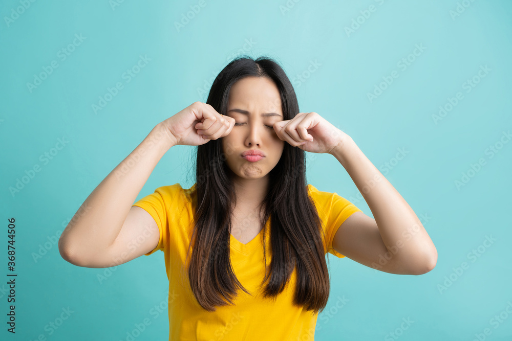 Asian woman she is crying on the green studio backdrop Asian woman she is crying on the green studio backdrop
