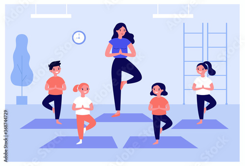 Smiling kids exercising in yoga class isolated flat vector illustration. Cartoon children doing exercises with instructor in gym. Healthy lifestyle and sport concept