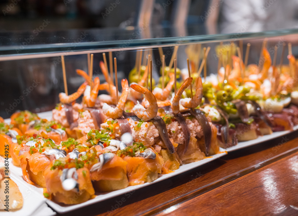 Fototapeta premium Delicious close up of pintxos/pinchos from San Sebastian (Donostia, Basque Autonomous community, Spain). Typical meal, kind of like spanish tapas.