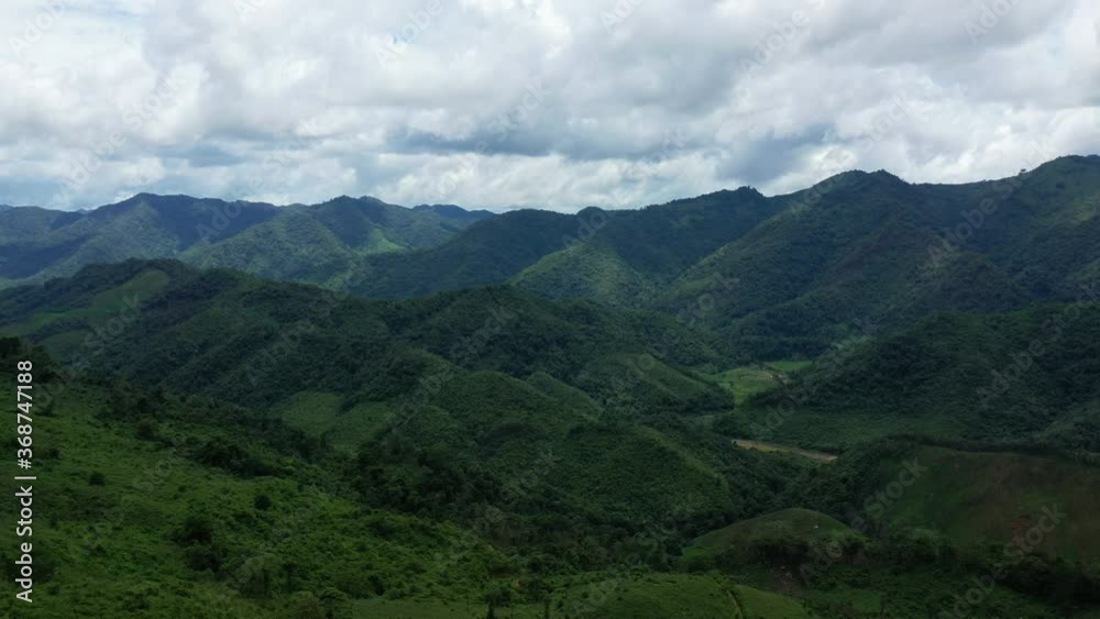The towering green mountains of the Laotian countryside in Asia, Laos, between Vientiane and Luang Prabang, in summer on a sunny day. The towering green mountains of the Laotian countryside in Asia, Laos, between Vientiane and Luang Prabang, in summer on a sunny day.