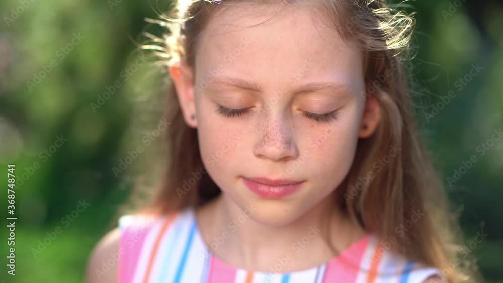 girl with freckles screws up eyes from sun and closes face straw hat girl with freckles screws up eyes from sun and closes face straw hat