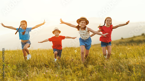 Happy children running in field.