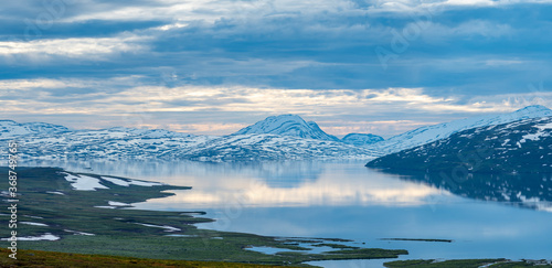 Beautiful Horizontal landscape North of the Arctic Circle in Swedish Lapland overlooking Big lake Vastenjaure on the Padjelanta Trail and The Border to Norway and Fjords reflection in the Water.