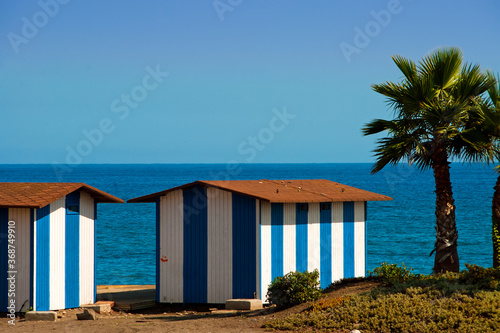 Palm trees and beach huts on Playa del Penoncillo Torrox Costa Andalusia Axarquia Costa del Sol Spain