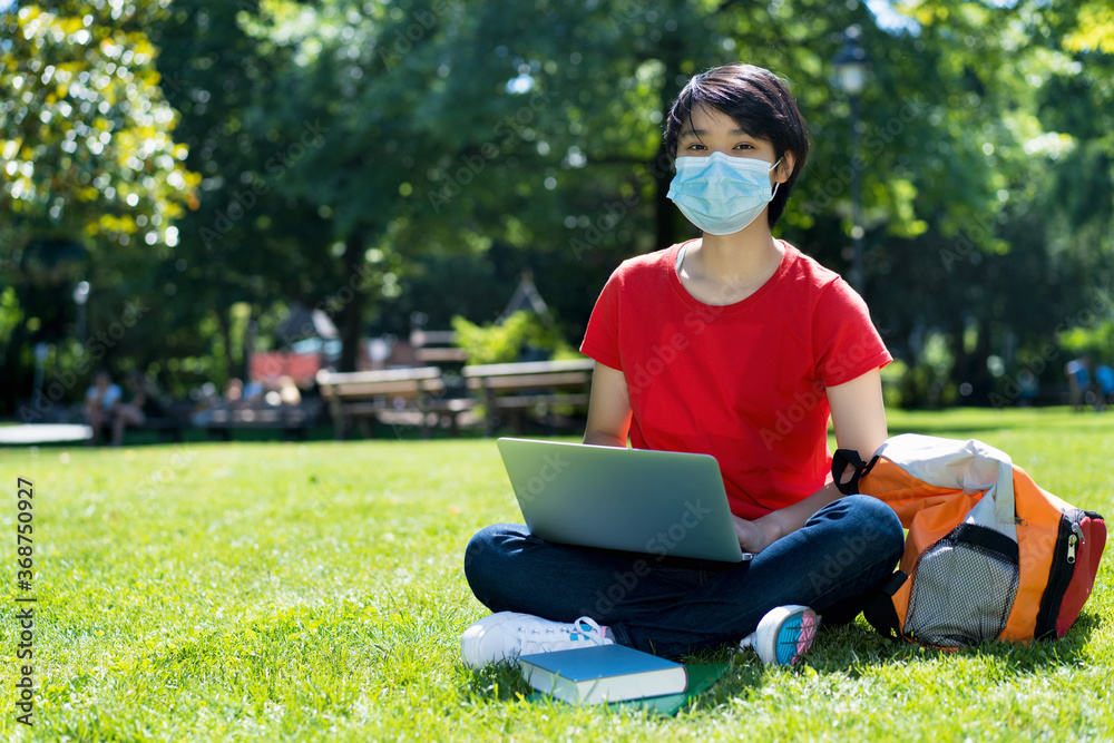 East asian male student with face mask at campus of university