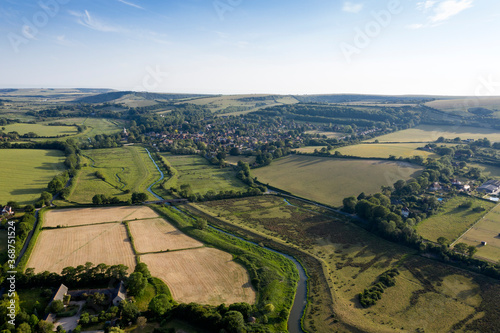 Beautiful drone landscape image over lush green Summer English countryside during late afternoon light