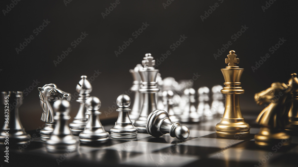 King golden chess standing confront of the silver chess team concepts of leadership and business strategy management and leadership.
