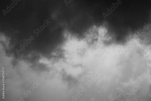 Natural toned emotional day sky background. Heavy cloud formation in stormy dark sky, strong wind and hard rain. Rainy season day atmosphere.