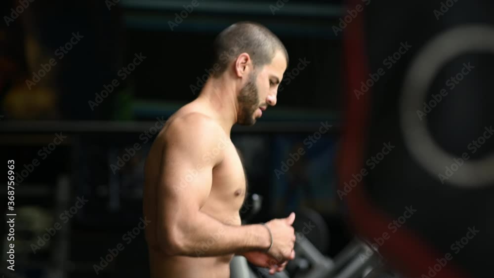 Man running in a gym on a treadmill concept for exercising, fitness and healthy lifestyle Man running in a gym on a treadmill concept for exercising, fitness and healthy lifestyle