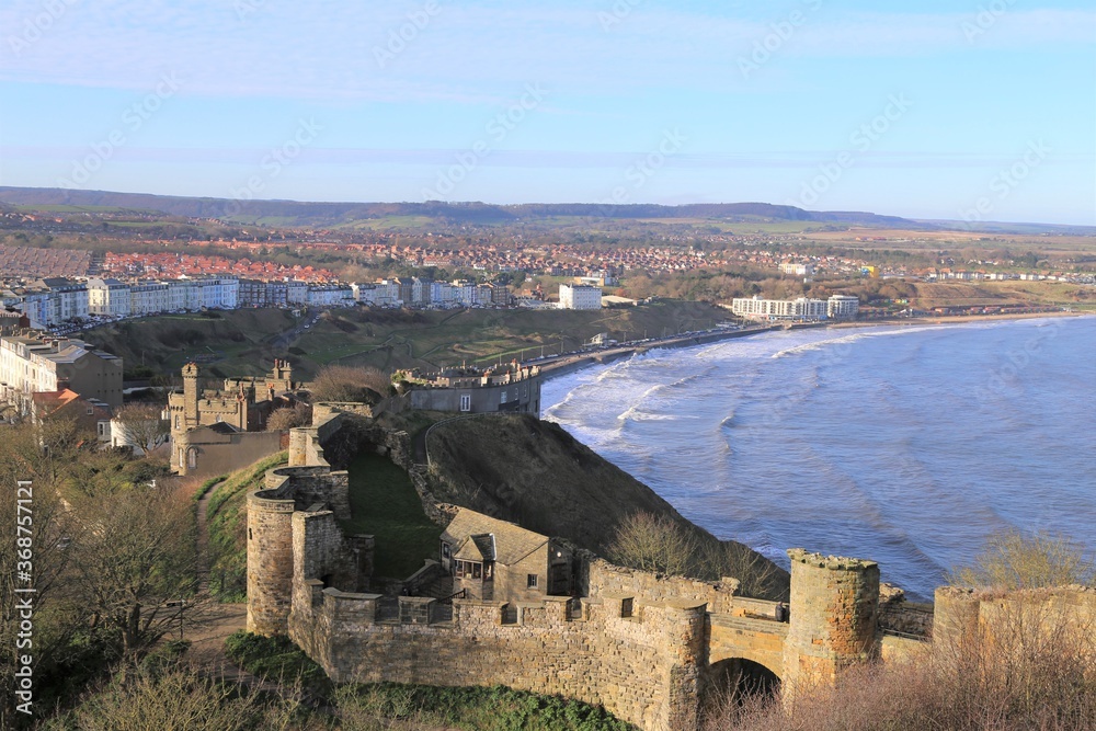 A view across the castle to the North Bay Beach and the northern residential district of Scarborough, Yorkshire, England, UK.