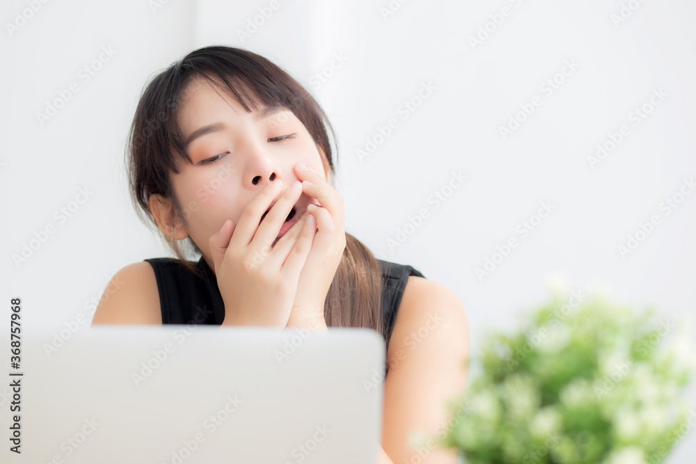 beautiful young freelance asian woman working bored and tired on laptop computer at the office, girl lazy sleepy and yawning on notebook, female secretary with exhausted, business concept. beautiful young freelance asian woman working bored and tired on laptop computer at the office, girl lazy sleepy and yawning on notebook, female secretary with exhausted, business concept.