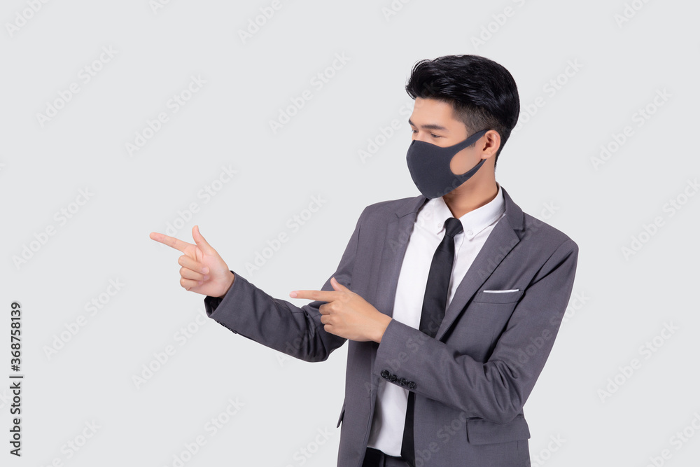 Portrait young asian businessman in suit wearing face mask for protective covid-19 isolated on white background, business man presenting and showing, quarantine for pandemic coronavirus, new normal. Portrait young asian businessman in suit wearing face mask for protective covid-19 isolated on white background, business man presenting and showing, quarantine for pandemic coronavirus, new normal.
